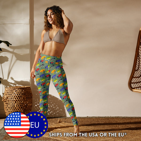 A model wearing frog leggings depicting an all-over print of multicoloured strawberry poison frogs on a green background.