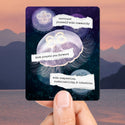 Magnet with motivational quote held by a hand against a scenic background